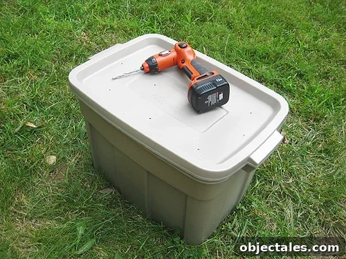 completed diy compost bin in plastic container with holes in top