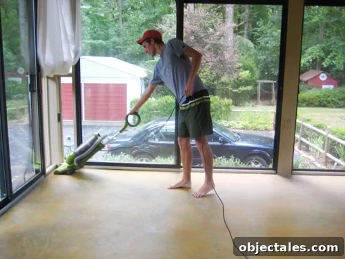 john-vacuums-for-prep cleaning concrete floor in glass doored sunroom prior to DIY stain application using a vacuum