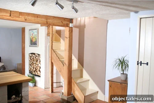 exposed light wood beam in english cottage including exposed staircase