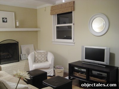 Wide shot of the painted round mirror above the TV