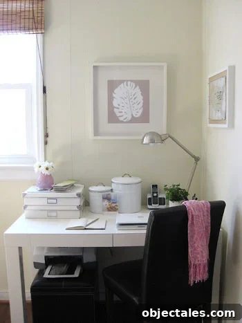 Small corner office with West Elm parsons desk with palm leaf artwork