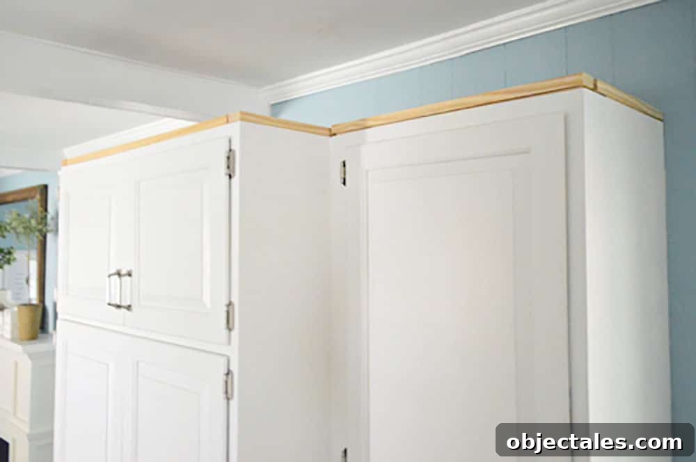 Install Crown Molding on Cabinets: DIY Step by Step Guide 7 Scrap wood nailed along perimeter of upper cabinet in kitchen