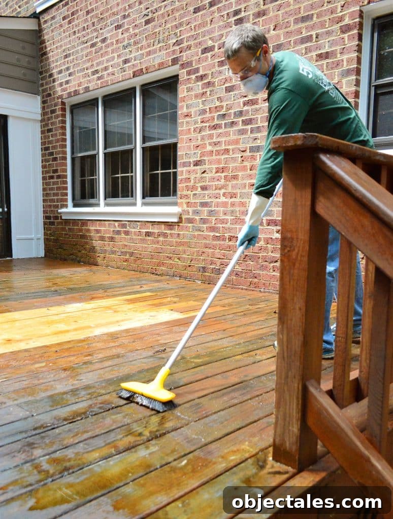 How to Strip a Deck for Staining: Remove Old Finish 11 John Scrubbing wood deck to remove old finish with stiff brush