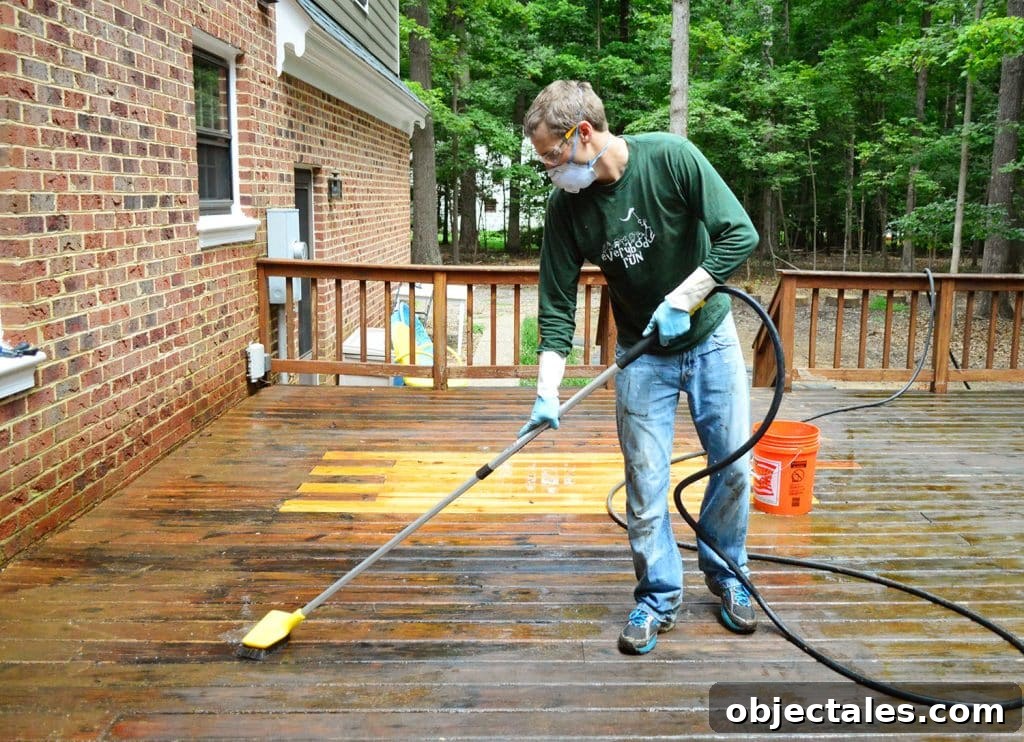 How to Strip a Deck for Staining: Remove Old Finish 13 John scrubbing deck with brush attached to hose