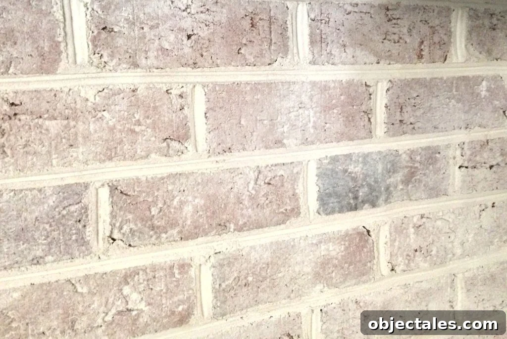 close up detail of brick wall fireplace with a DIY whitewash treatment applied