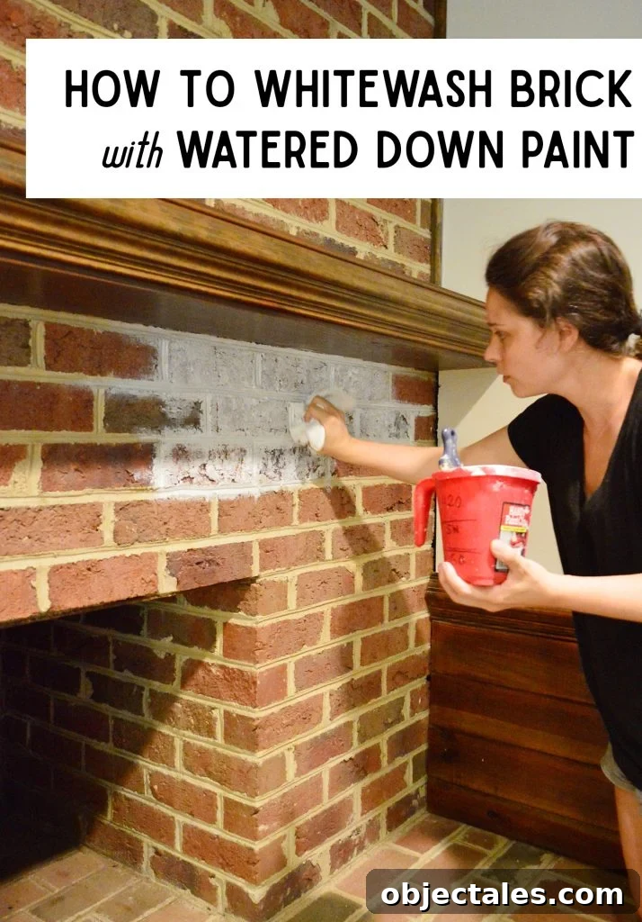 Sherry dabbing watered down paint onto red brick fireplace for whitewash effect