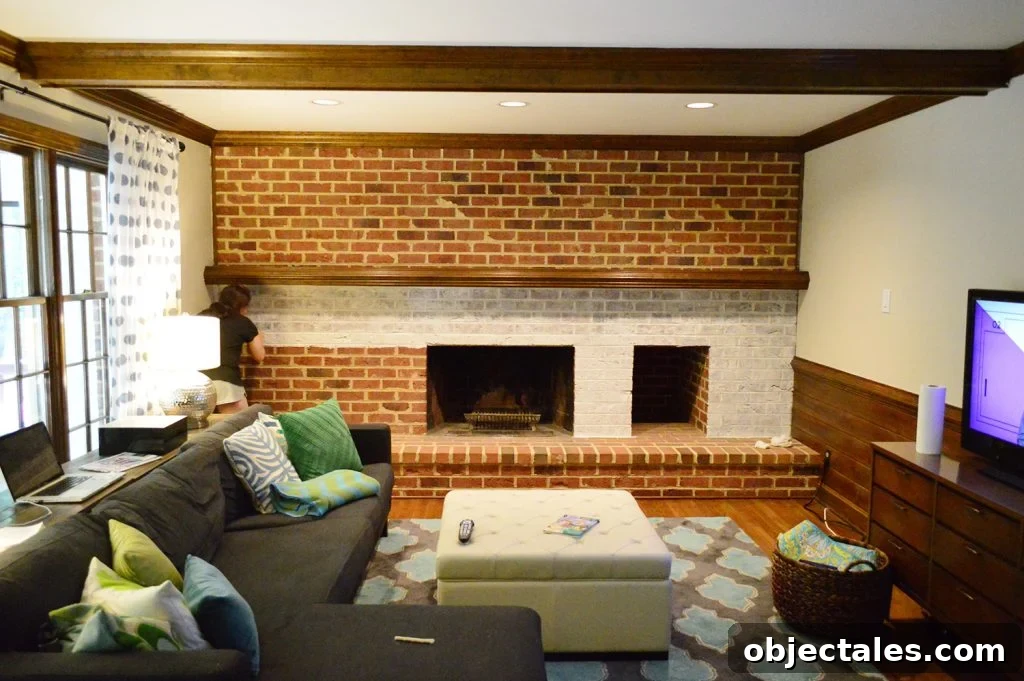whitewash brick technique being applied to living room fireplace wall made of brick