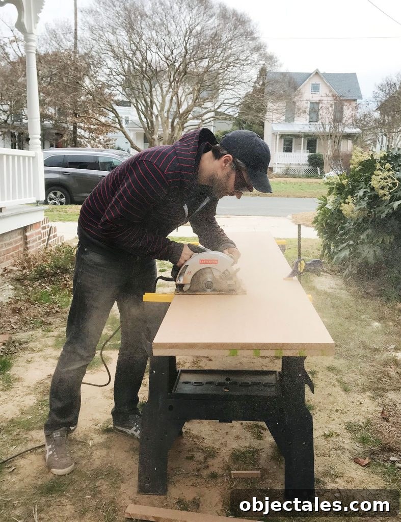 Man cutting MDF using a circular saw