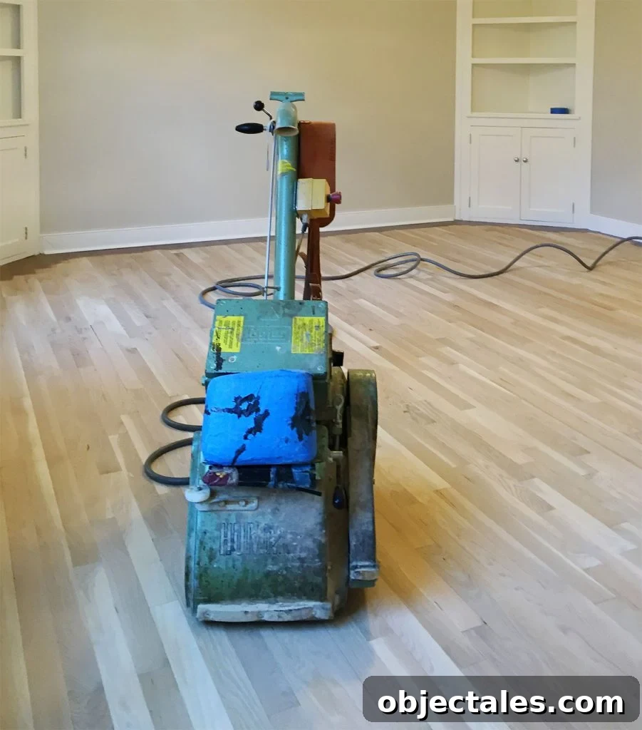 Professional floor sander on bare sanded oak floors