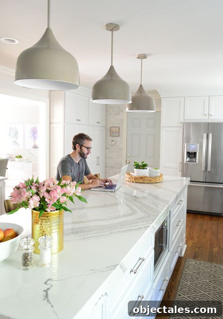 Kitchen Remodel Complete: Before and After Photos 9 white-kitchen-remodel-john-working-at-island