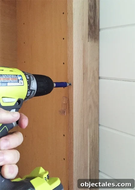 Build Custom Built-In Bookshelves: A Step-by-Step Guide 12 Screwing filler piece next to base cabinet for bookshelves