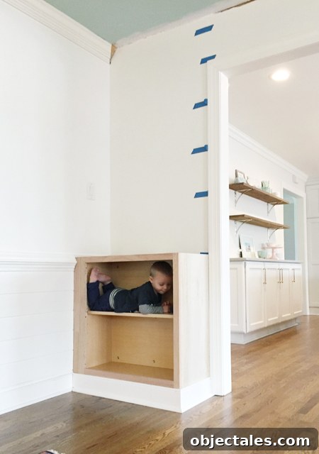 Build Custom Built-In Bookshelves: A Step-by-Step Guide 13 Base cabinet installed for built-in bookshelf with toddler inside