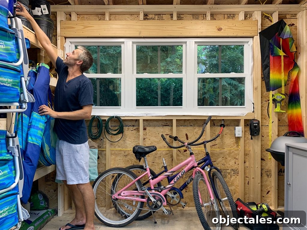 John reaching for something in beach house shed