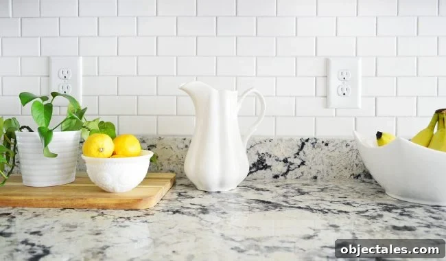 bright white subway tile backsplash in kitchen with gray granite counters
