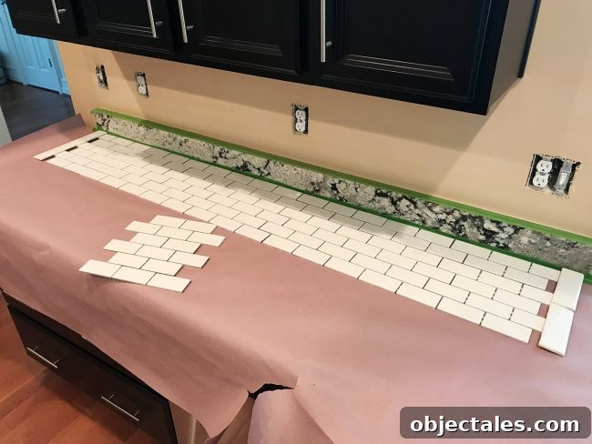 white subway tile sheets laid out on counter to finalize placement