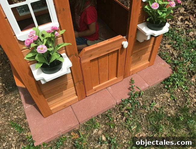 backyard discoveries cedar wooden playhouse with red paver base