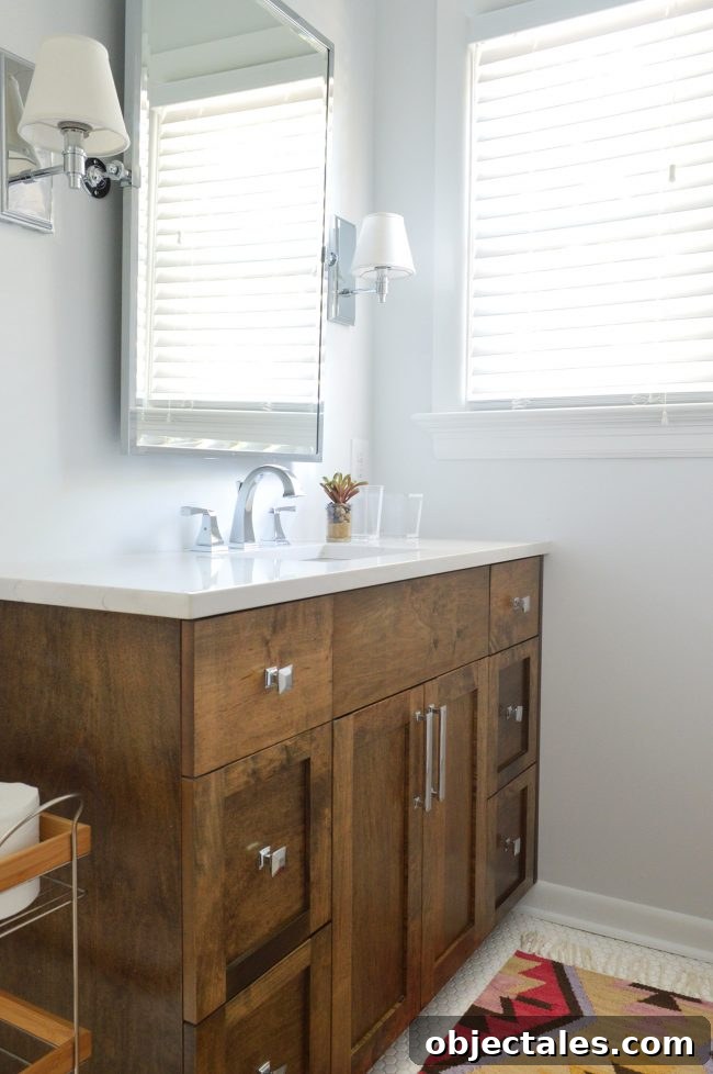 Turn Your House Into a Rental: Renovation Checklist 9 Bathroom with white hex tile floor and wood vanity