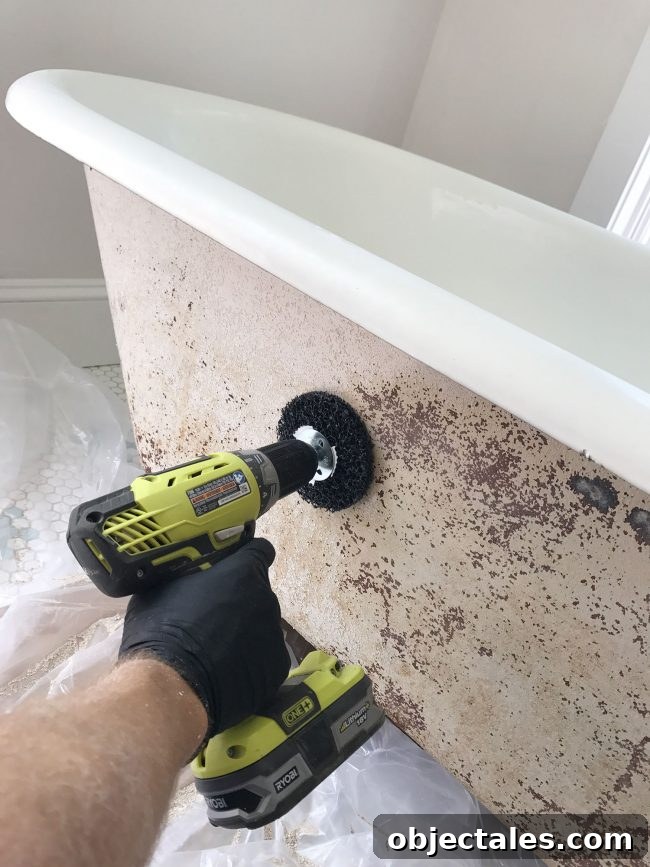 Refinish Your Old Clawfoot Tub: Step-by-Step Guide 12 Sanding attachment on drill buffing the outside of old clawfoot tub