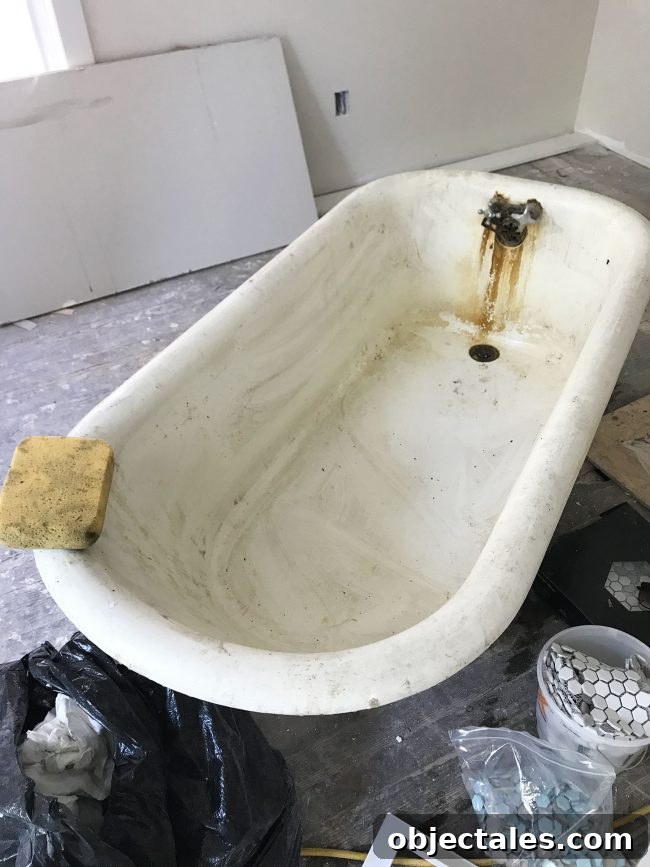 Refinish Your Old Clawfoot Tub: Step-by-Step Guide 6 Dirty inside of old clawfoot tub with sponge