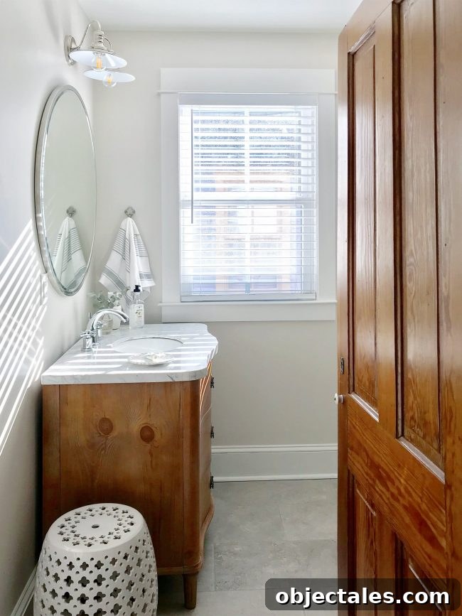 Hall bath vanity with round mirror