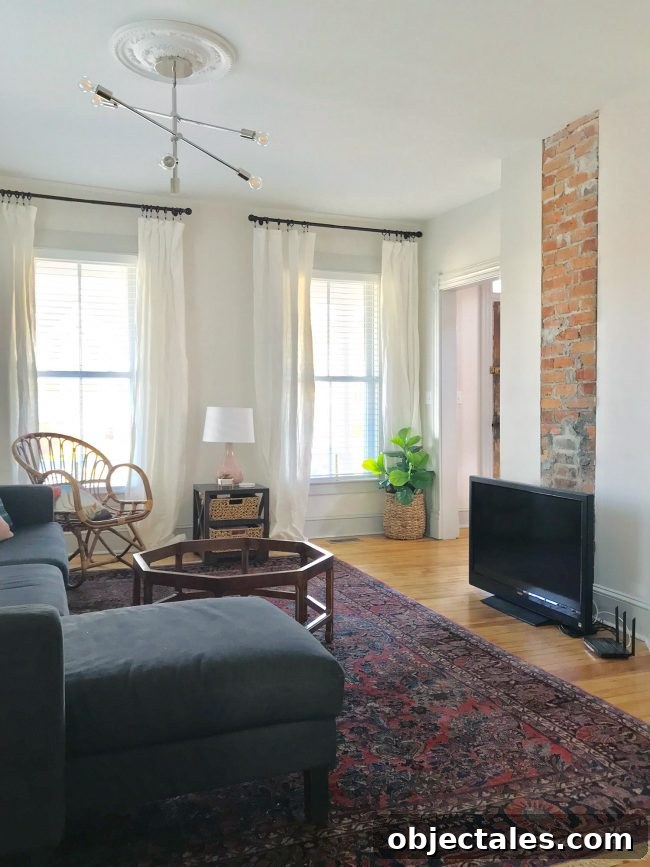 Living room with chandelier and exposed brick