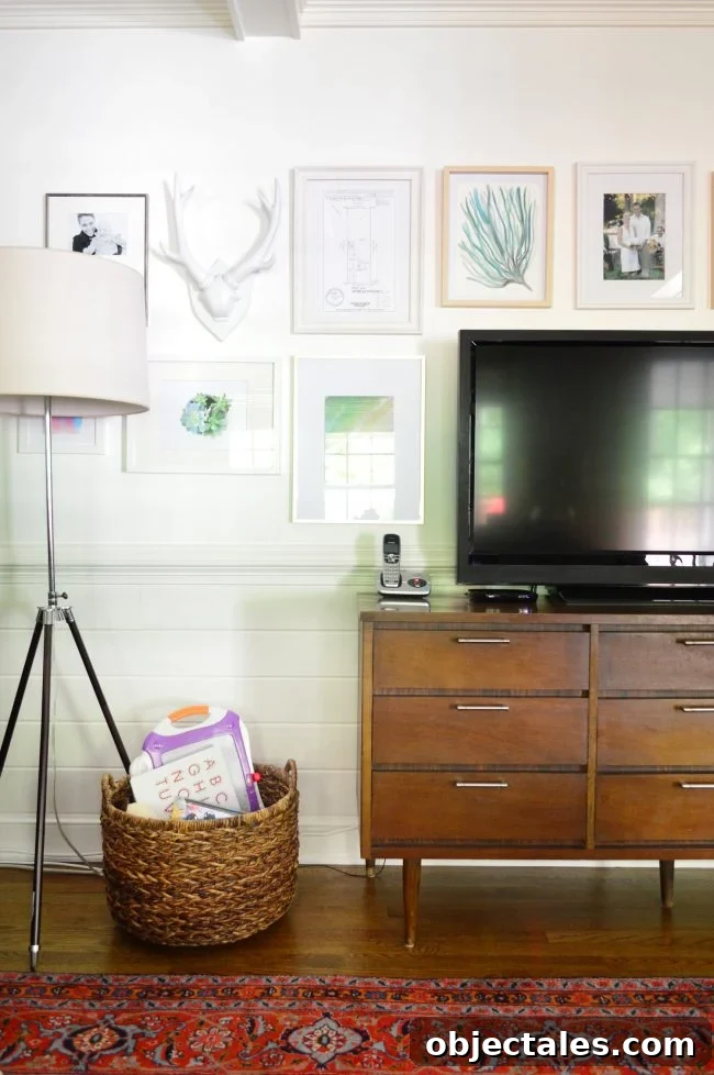How to Hang Picture Frames Around a Wall-Mounted TV 4 before photo of gallery wall around a TV before it was mounted to the wall