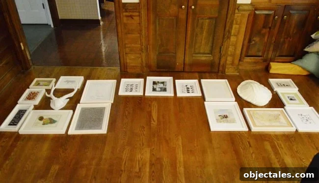 How to Hang Picture Frames Around a Wall-Mounted TV 6 picture frames laid out on a floor in preparation for gallery wall