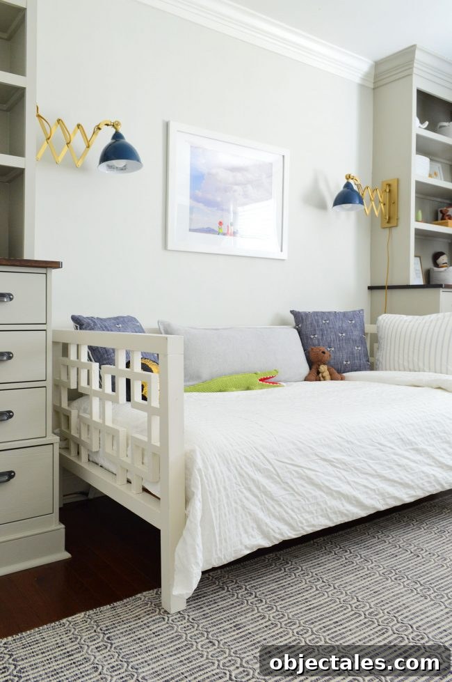 Brass and blue enamel sconce above bed