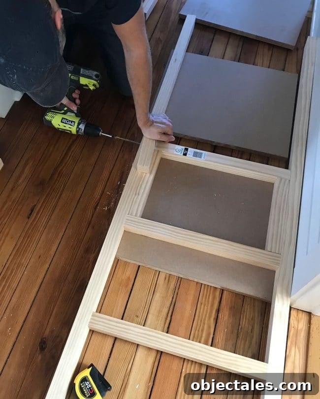 How to Build Built-In Bunk Beds: Step-by-Step Guide 17 screwing 2x2 wood pieces together to create bunk bed ladder