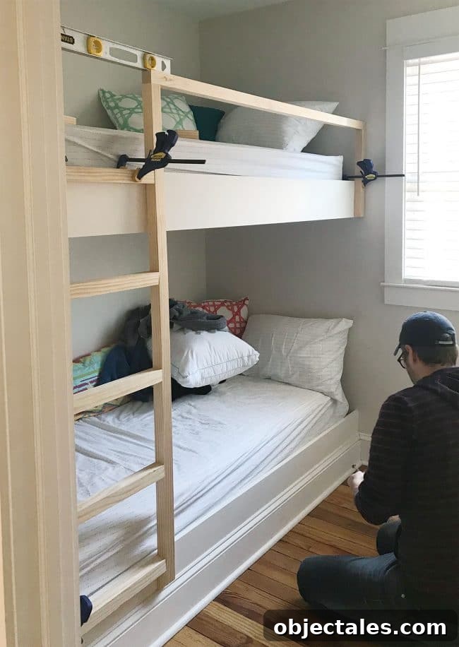 How to Build Built-In Bunk Beds: Step-by-Step Guide 18 clamps holding diy bunk bed ladder and railings in place