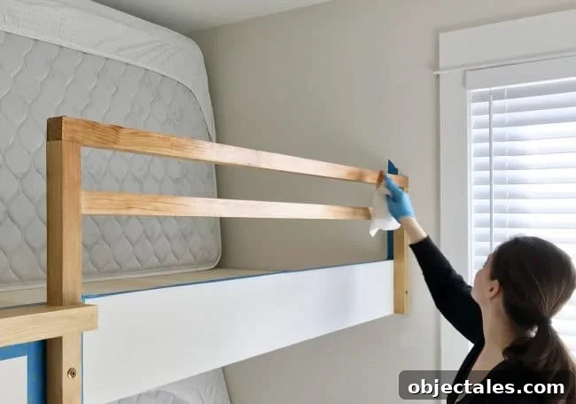 How to Build Built-In Bunk Beds: Plans & Step-by-Step 13 Sherry applying stain to bunk bed railing for raw wood look
