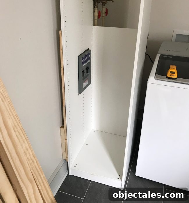 Conceal Your Water Heater with an IKEA Cabinet 8 ikea pax wardrobe pressed against wall with cutouts for breaker box