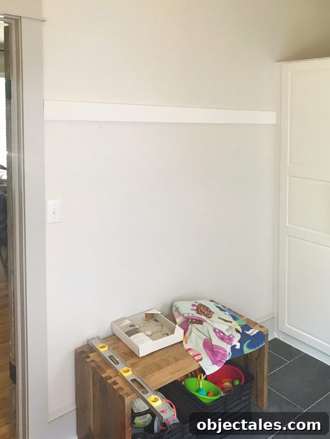 Build a Long Hook Rail for Your Mudroom 4 white board hung on wall in mudroom