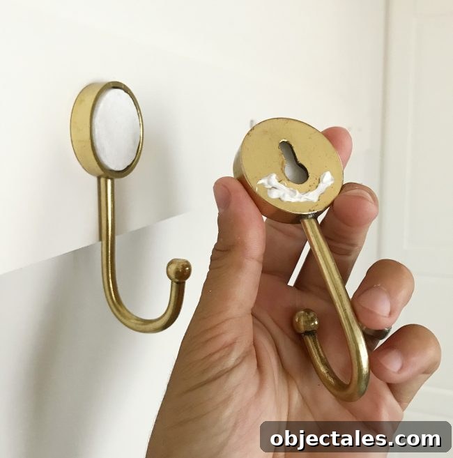 Build a Long Hook Rail for Your Mudroom 5 caulk on back of gold hook before being hung on wall