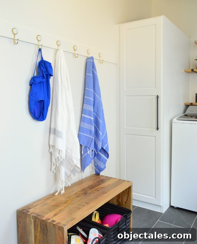 Build a Long Hook Rail for Your Mudroom 6 after photo of towels and bathing suit on hook rail in mudroom