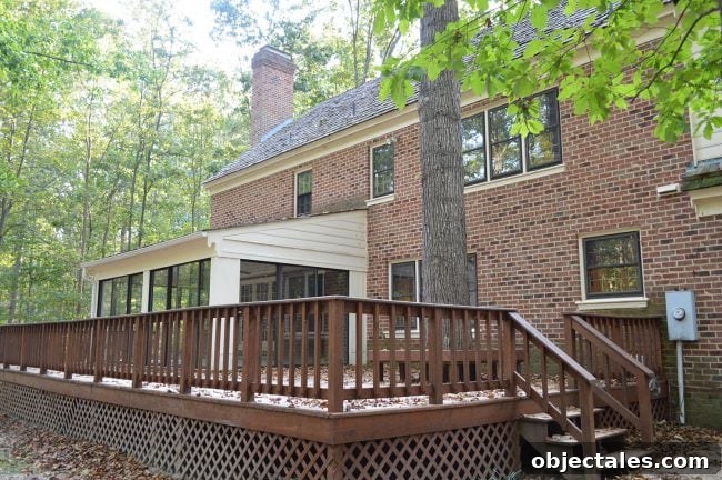 How We Painted Our Brick House White 12 before photo of back of brick house with large deck