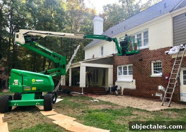 How We Painted Our Brick House White 19 large crane lift used to paint the back of a brick house white