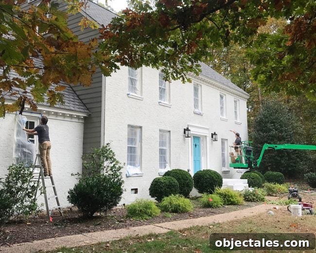 How We Painted Our Brick House White 20 painters applying second coat of romabio biodomus paint to brick house
