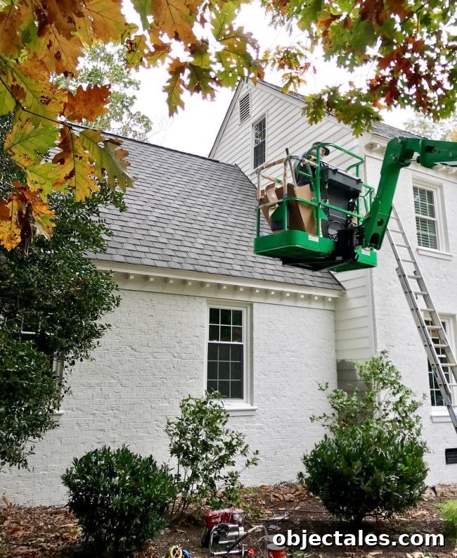 How We Painted Our Brick House White 21 painter in crane painting siding of a brick house white