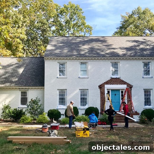 How We Painted Our Brick House White 25 contractors working to rebuilt portico of brick house during painting