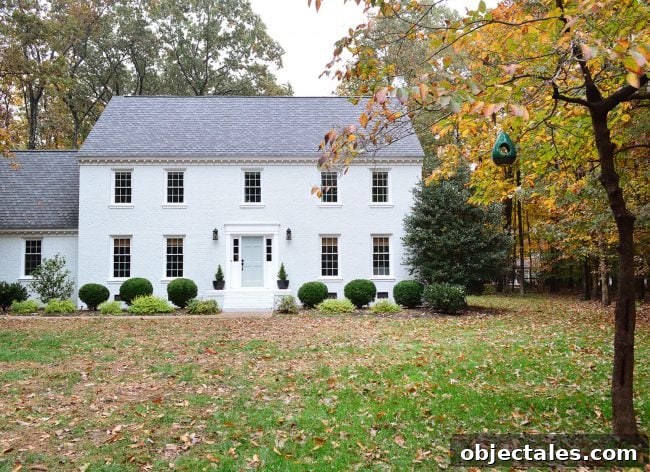How We Painted Our Brick House White 7 white painted brick house with fall leave and tranquility blue door