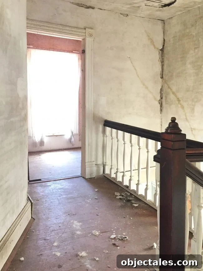 Beach House Before and After: Upstairs Transformation 3 beach house before upstairs landing crumbling drywall painted floor