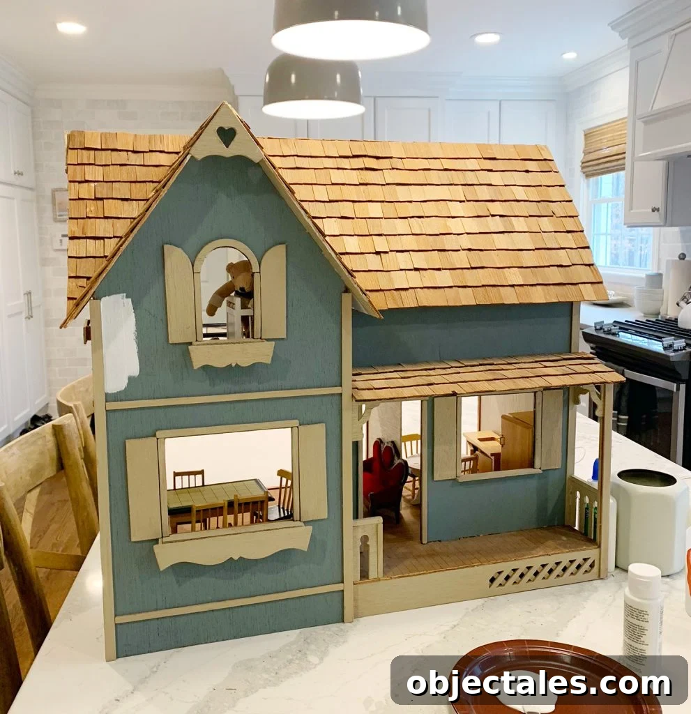Dollhouse before makeover with partial white paint
