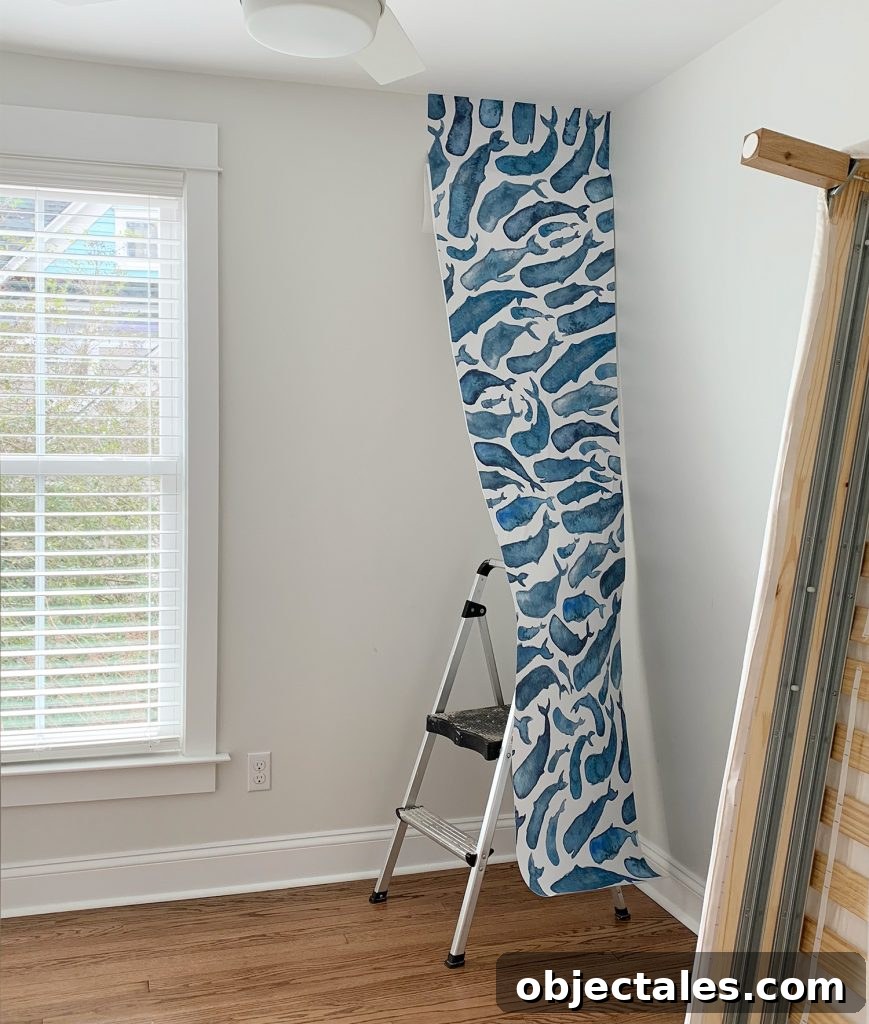 How to Install a Peel-and-Stick Wall Mural 6 One Panel Of Whale Removable Wallpaper Partially Hung In Room