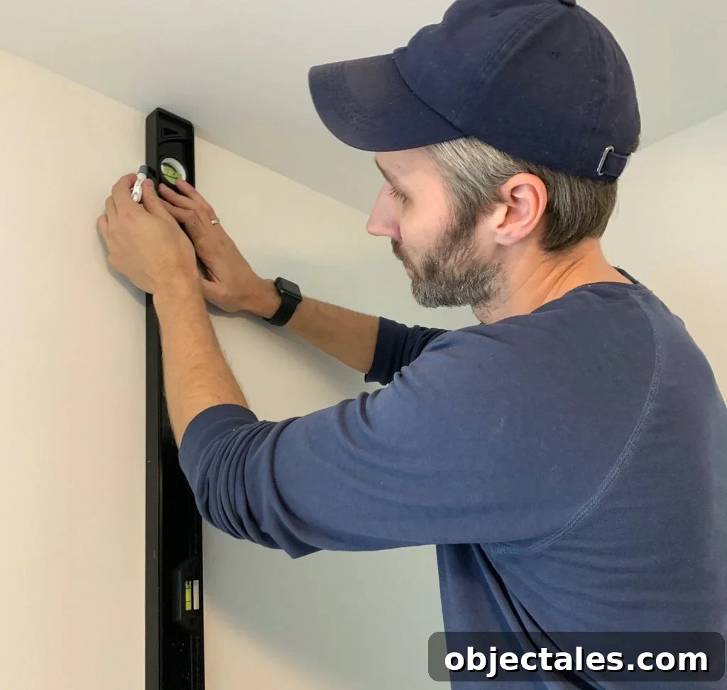 How to Install a Peel-and-Stick Wall Mural 7 Drawing Vertical Level Line Before Hanging First Panel of Wallpaper