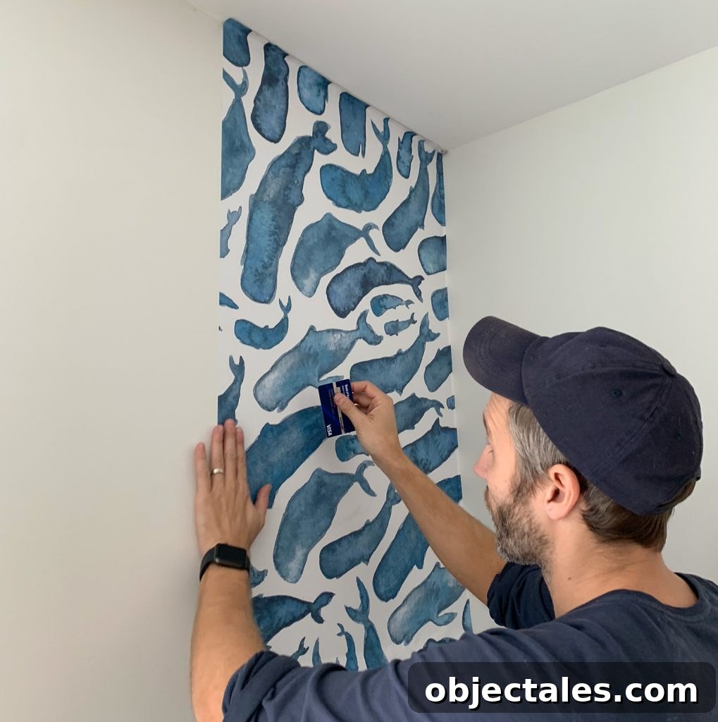 How to Install a Peel-and-Stick Wall Mural 9 Smoothing Removable Wallpaper With Credit Card