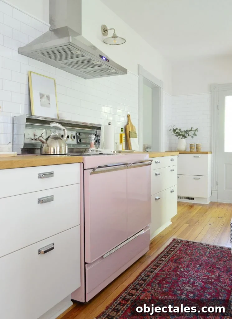 beach house kitchen with pink stove and white subway backsplash