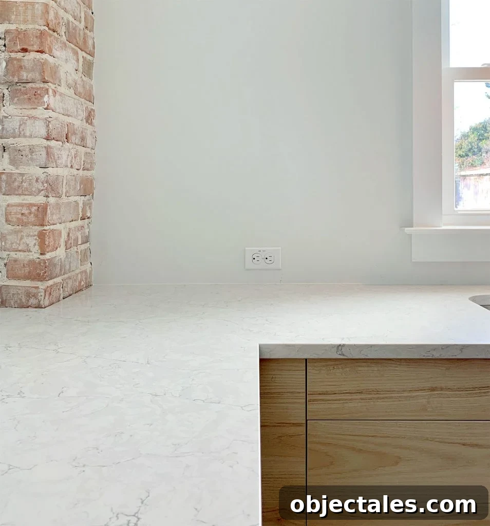 Silestone Pearl Jasmine Quartz counters with wood cabinets and brick chimney