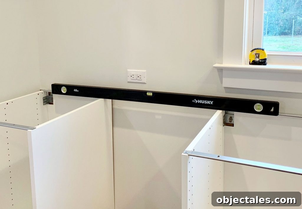 How to Install IKEA Kitchen Cabinets: Step-by-Step 14 Long level across cabinet run