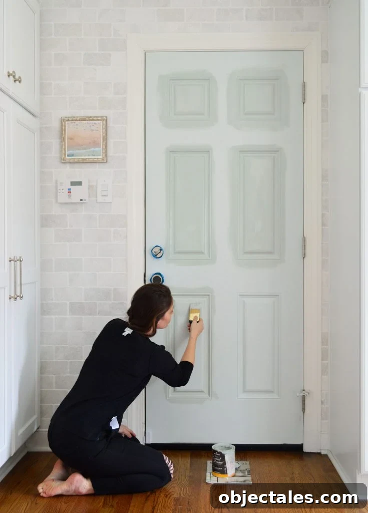 Front Door Paint Guide: Top Paint Choices and Pro Tips 8 Sherry Applying High Gloss Paint To Kitchen Door With Short Angled Brush